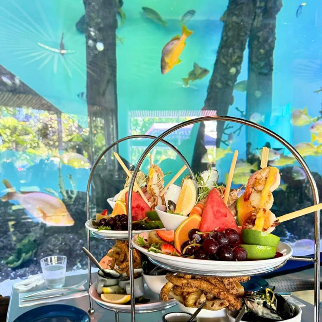 Seafood Dish on A Table Near Large Aquarium